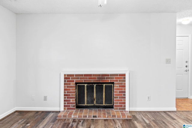 details featuring a textured ceiling, wood-type flooring, and a fireplace