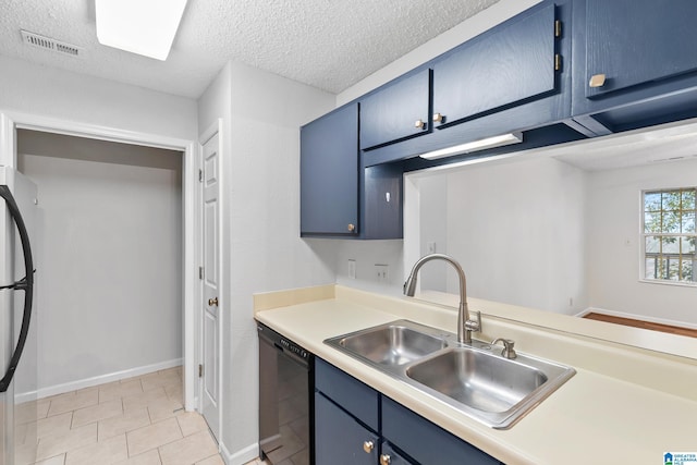 kitchen with stainless steel fridge, a textured ceiling, sink, blue cabinetry, and black dishwasher