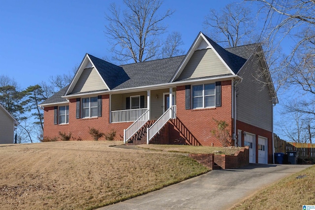 view of front of home featuring covered porch, a garage, and a front yard