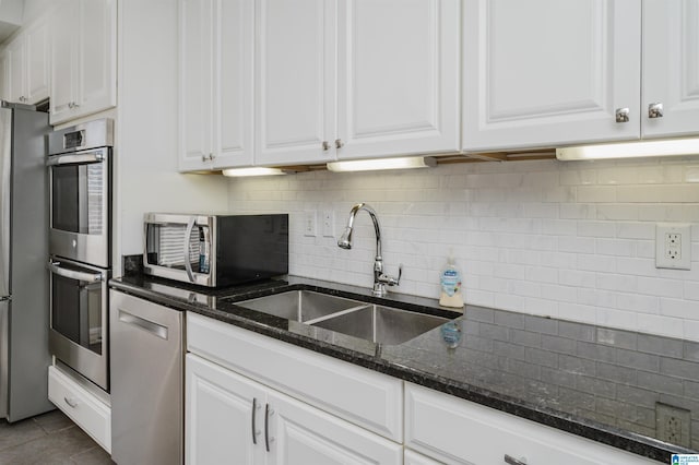 kitchen featuring white cabinets, appliances with stainless steel finishes, and sink