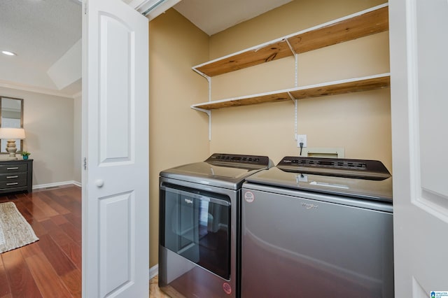 laundry room featuring washer and dryer and dark hardwood / wood-style floors