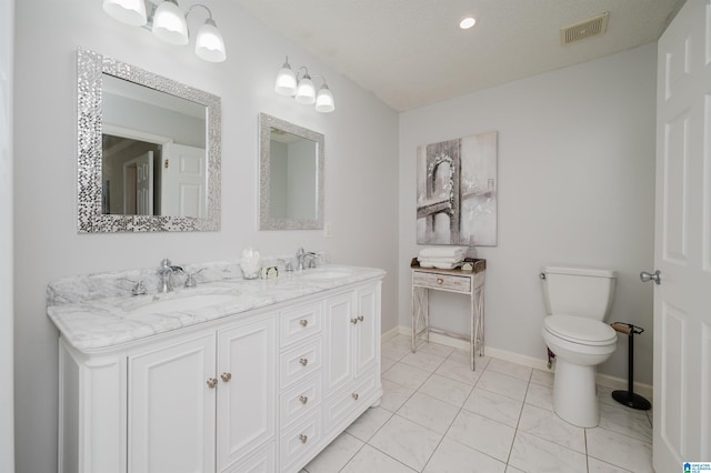 bathroom with tile patterned floors, vanity, and toilet