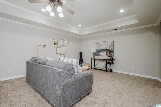 living room featuring ceiling fan, crown molding, and a tray ceiling