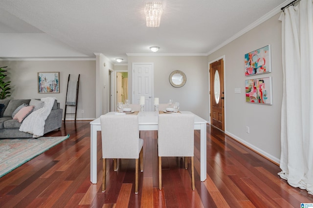 dining space featuring dark hardwood / wood-style flooring, a notable chandelier, and ornamental molding