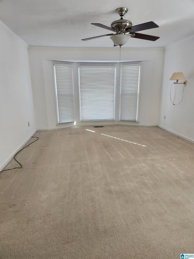 carpeted empty room with ceiling fan