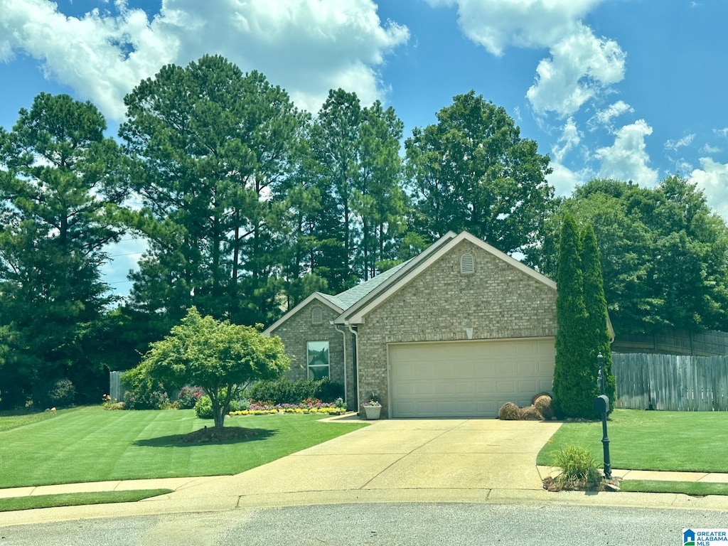 view of front of house with a garage and a front yard