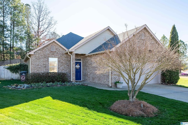 view of property featuring a garage and a front yard