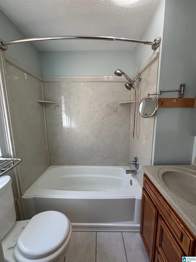 full bathroom with vanity, tile patterned floors, washtub / shower combination, toilet, and a textured ceiling