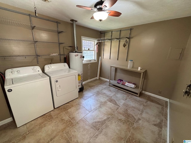 washroom with a textured ceiling, gas water heater, ceiling fan, and washing machine and clothes dryer