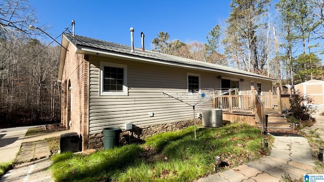 view of front of property featuring central AC and a deck