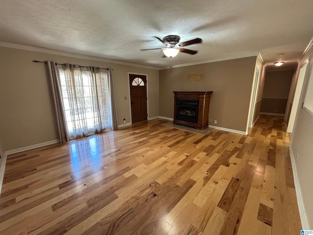 unfurnished living room with ceiling fan, crown molding, a textured ceiling, and light hardwood / wood-style flooring