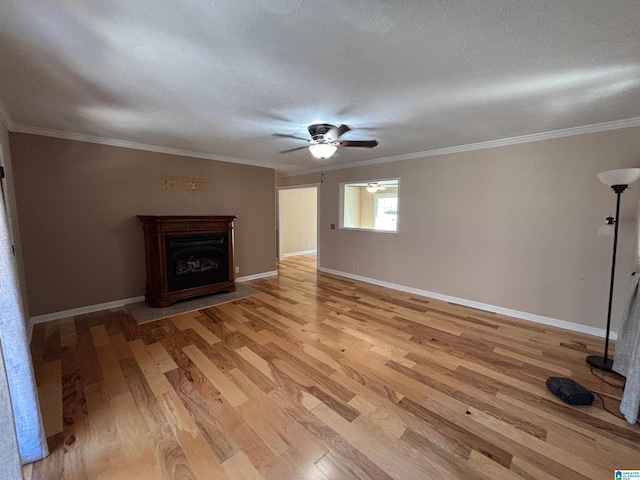 unfurnished living room featuring ceiling fan, light hardwood / wood-style floors, and ornamental molding