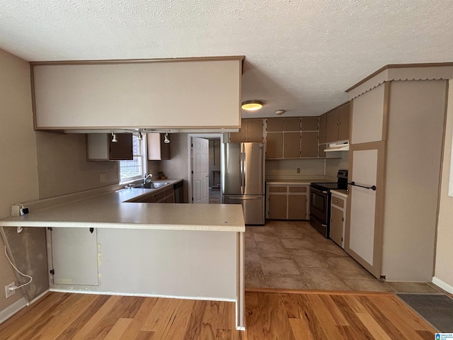 kitchen with stainless steel refrigerator, electric range, gray cabinetry, sink, and kitchen peninsula