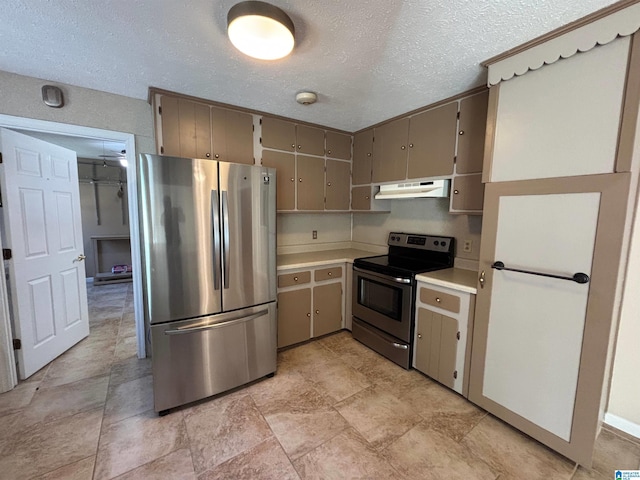 kitchen with gray cabinets, a textured ceiling, and appliances with stainless steel finishes