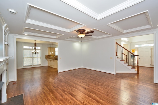 unfurnished living room with ceiling fan with notable chandelier, dark hardwood / wood-style floors, ornamental molding, and coffered ceiling