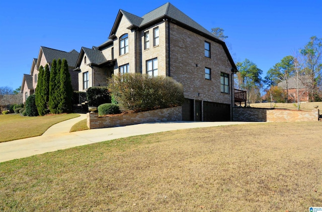 view of property exterior with a yard and a garage