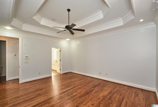 spare room featuring a raised ceiling, ceiling fan, and crown molding