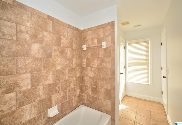 bathroom with tile patterned floors and tiled shower / bath combo