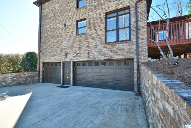 view of side of home featuring a garage and a deck