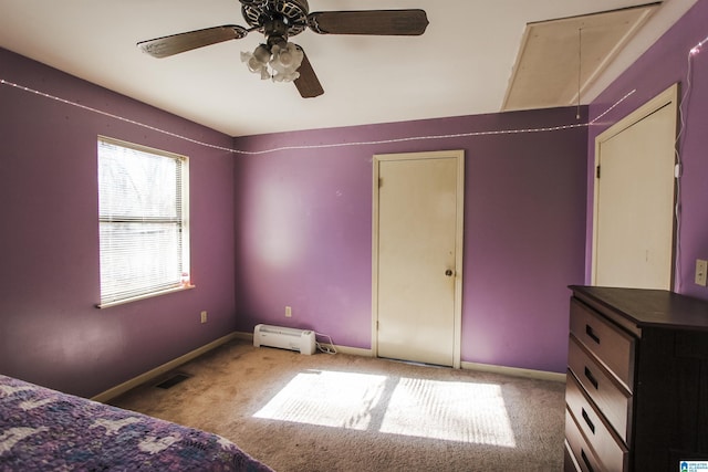 unfurnished bedroom featuring ceiling fan, carpet, and a baseboard heating unit