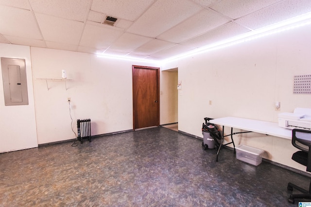 interior space with radiator, electric panel, and a drop ceiling