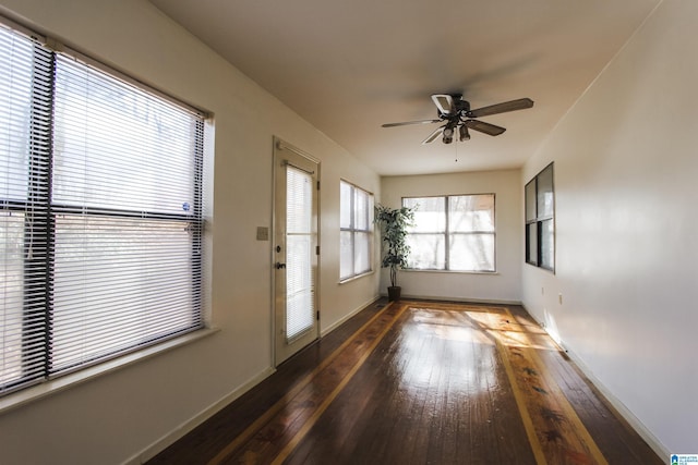 doorway featuring ceiling fan and dark wood-type flooring