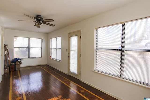 doorway to outside featuring ceiling fan and dark hardwood / wood-style floors