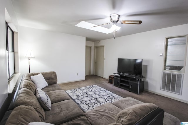 carpeted living room featuring a skylight and ceiling fan