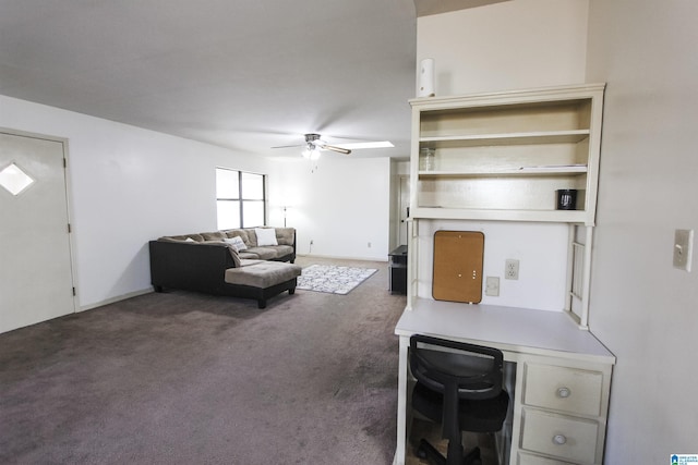 living room with ceiling fan and dark colored carpet