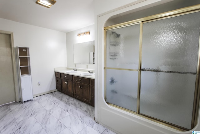 bathroom featuring shower / bath combination with glass door and vanity