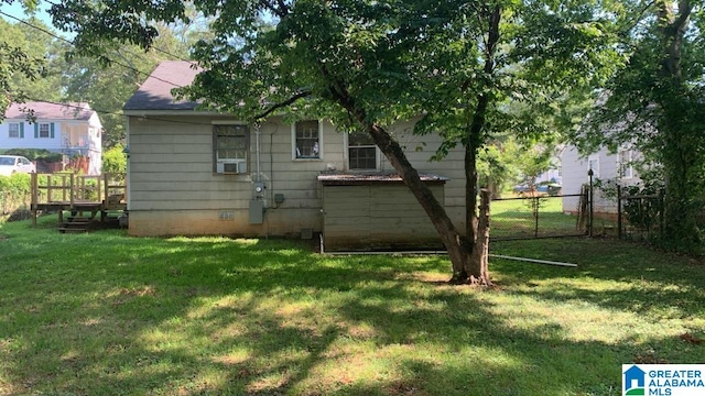 back of house with a lawn and cooling unit