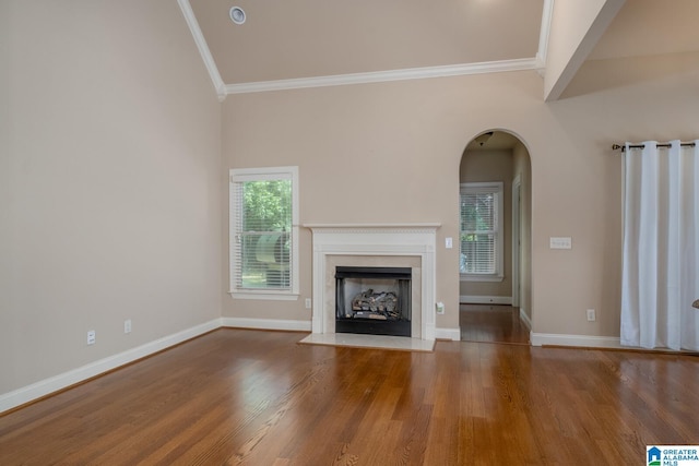 unfurnished living room featuring hardwood / wood-style flooring, lofted ceiling, and crown molding