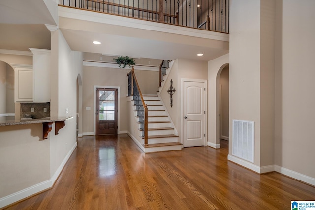 entryway featuring a high ceiling and light wood-type flooring