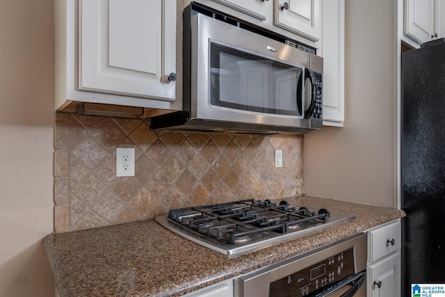 kitchen featuring backsplash, white cabinetry, and appliances with stainless steel finishes