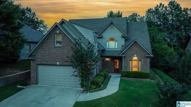 view of front of house with a yard and a garage