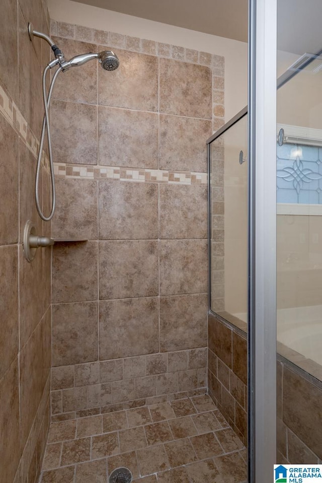 bathroom with a shower with shower door