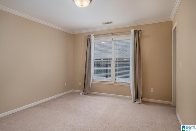 empty room featuring ornamental molding and light carpet