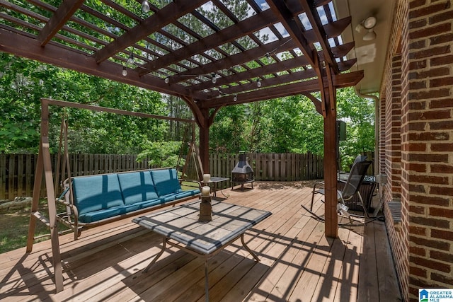 wooden terrace with a pergola and outdoor lounge area