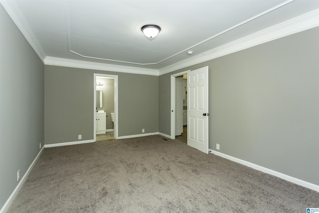 unfurnished bedroom with carpet, ensuite bathroom, and ornamental molding