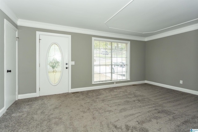 foyer entrance featuring carpet and ornamental molding