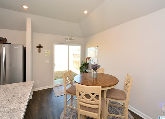 dining room featuring dark hardwood / wood-style floors and lofted ceiling