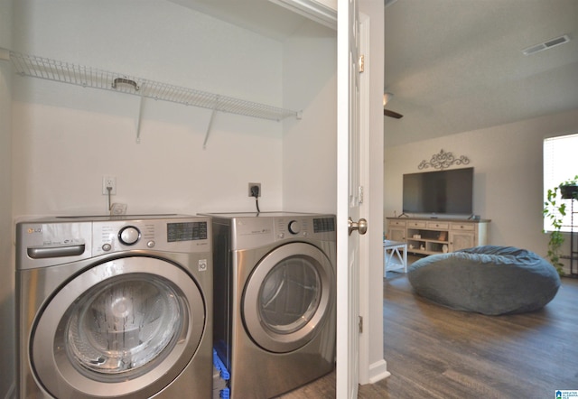 washroom with washer and clothes dryer and hardwood / wood-style flooring