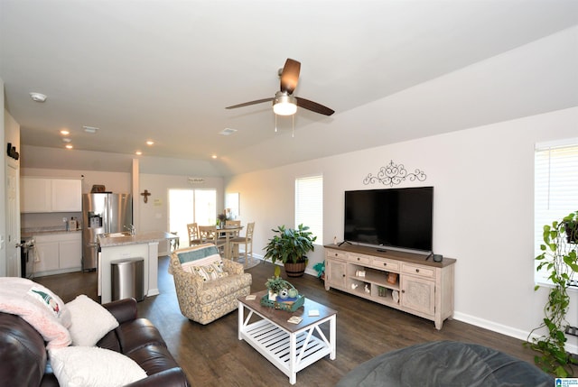 living room with dark hardwood / wood-style flooring, ceiling fan, and lofted ceiling