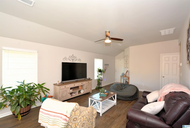 living room with dark hardwood / wood-style floors, ceiling fan, and vaulted ceiling