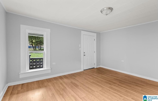 unfurnished room featuring light hardwood / wood-style flooring and crown molding