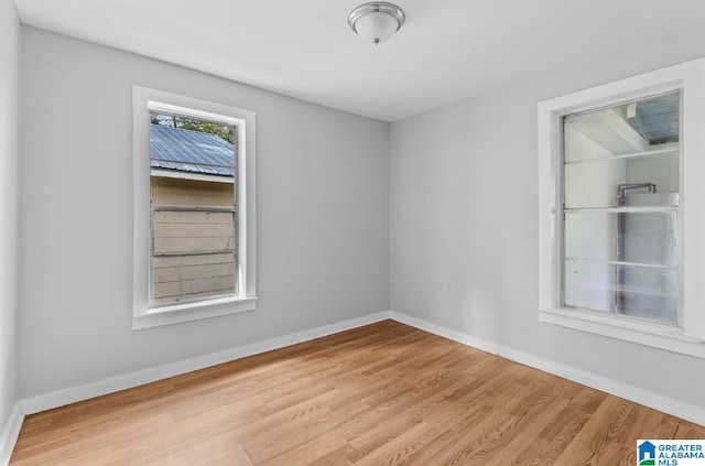 empty room with light hardwood / wood-style flooring