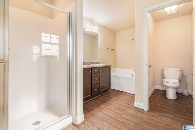 full bathroom featuring wood-type flooring, toilet, separate shower and tub, and vanity