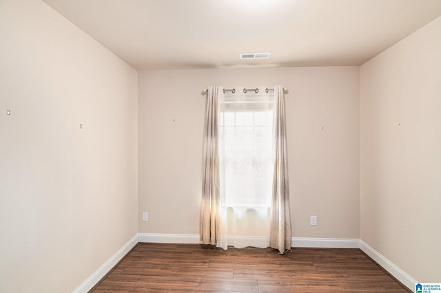 spare room featuring dark hardwood / wood-style floors