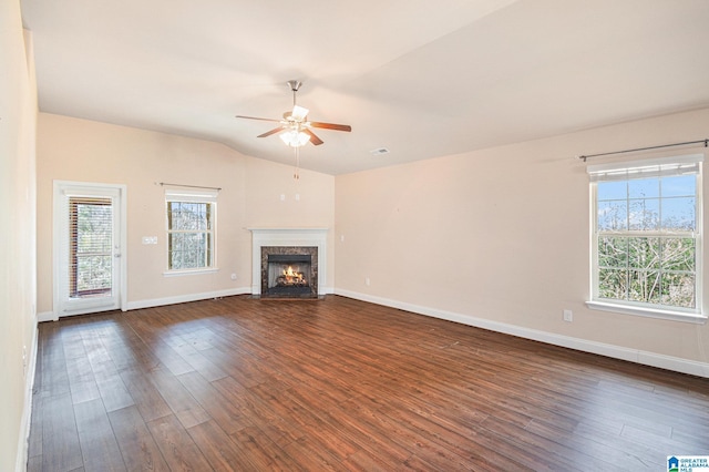 unfurnished living room featuring ceiling fan, lofted ceiling, dark wood-type flooring, and a high end fireplace