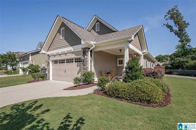 craftsman-style house with a garage and a front lawn